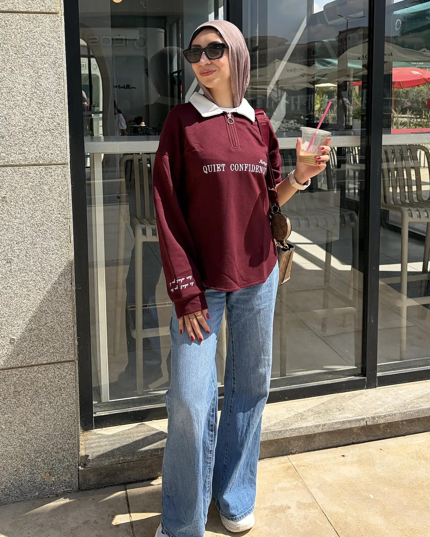 Full-length look: burgundy quarter-zip, wide-leg jeans and white trainers