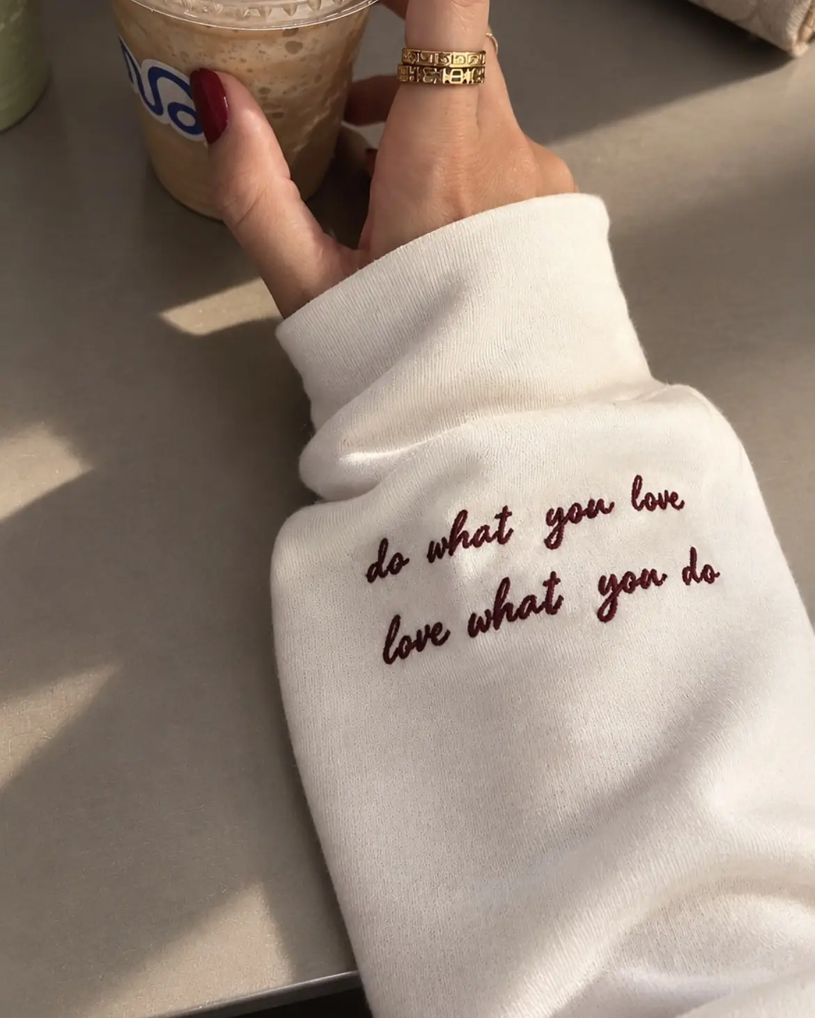 White cuff embroidered in burgundy: do what you love, love what you do