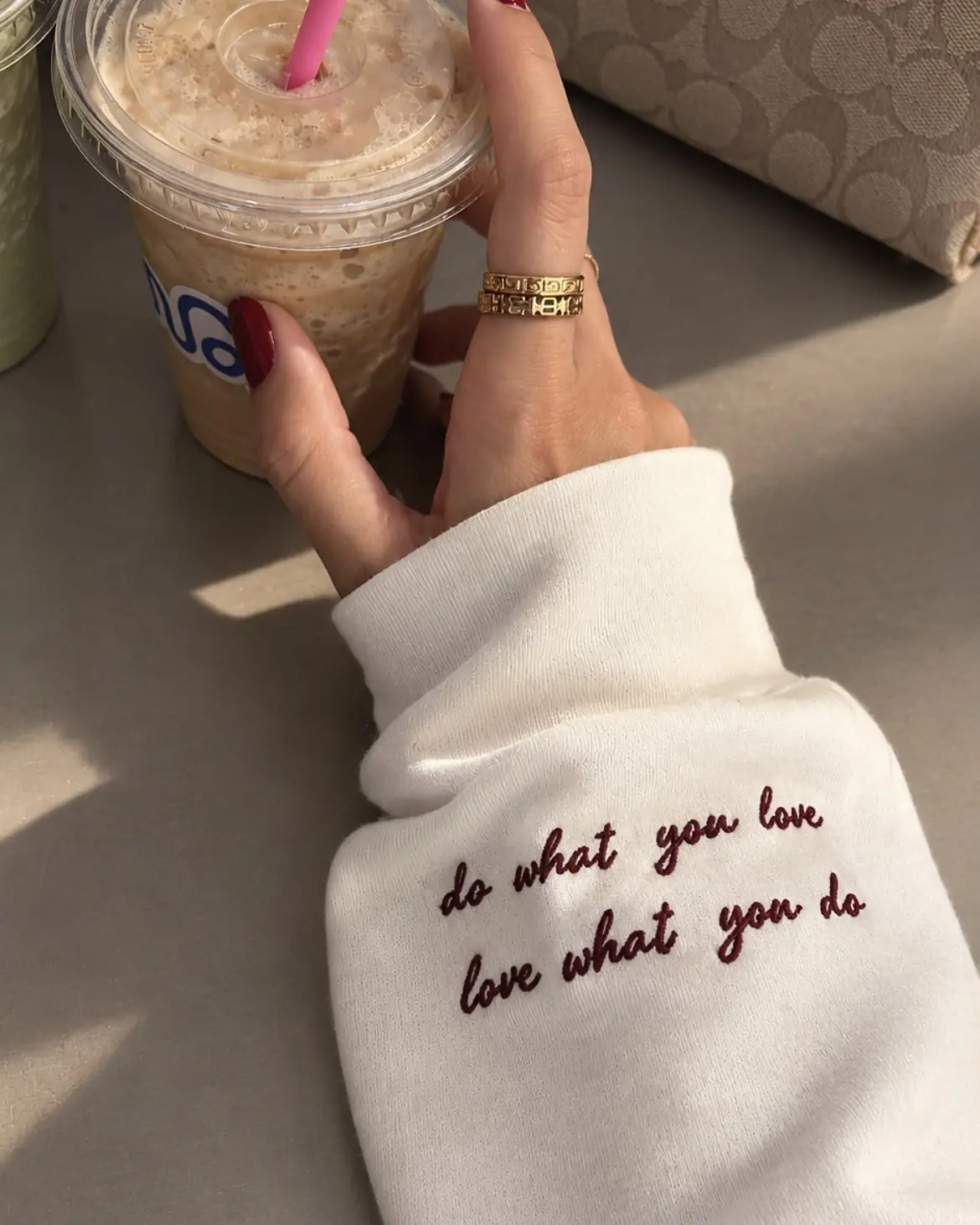 White cuff embroidered in burgundy: do what you love, love what you do