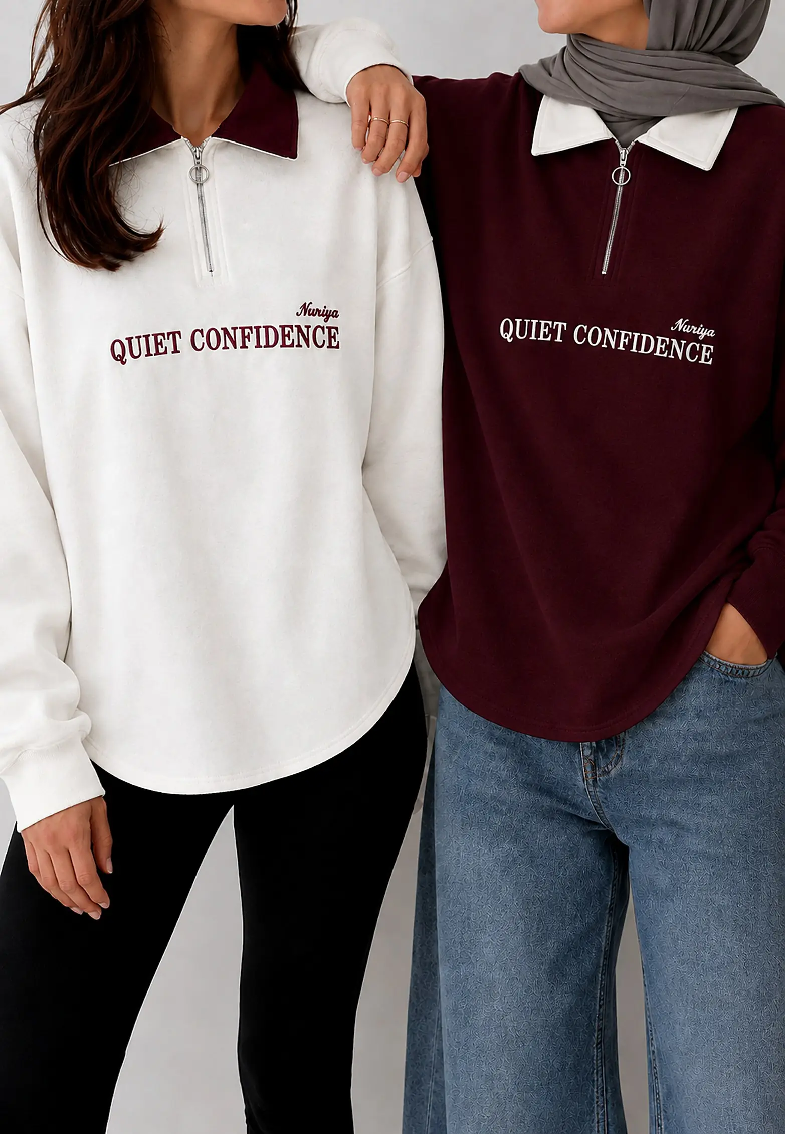 Two girls in the Quiet Confidence quarter-zip, one in white with a burgundy collar and one in burgundy with a white collar
